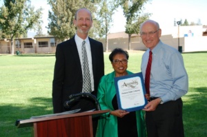 Company President Bob Nicholson (l) and Chairman and CEO Mike Whitehead receive a congratulatory California State Assembly Resolution from Assembly Member Cheryl Brown.