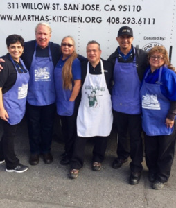 SJWC employee volunteers prepare food at Martha’s Kitchen.